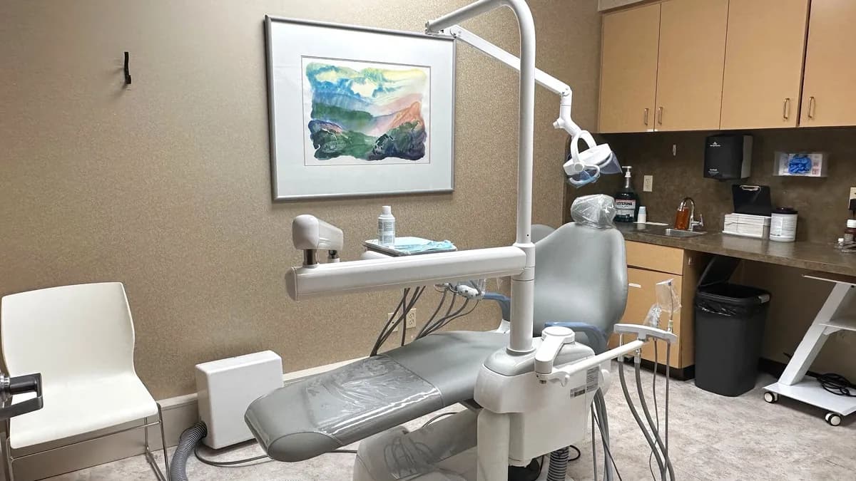 A treatment room with a surgical chair and natural light at OAKS Oral Surgery